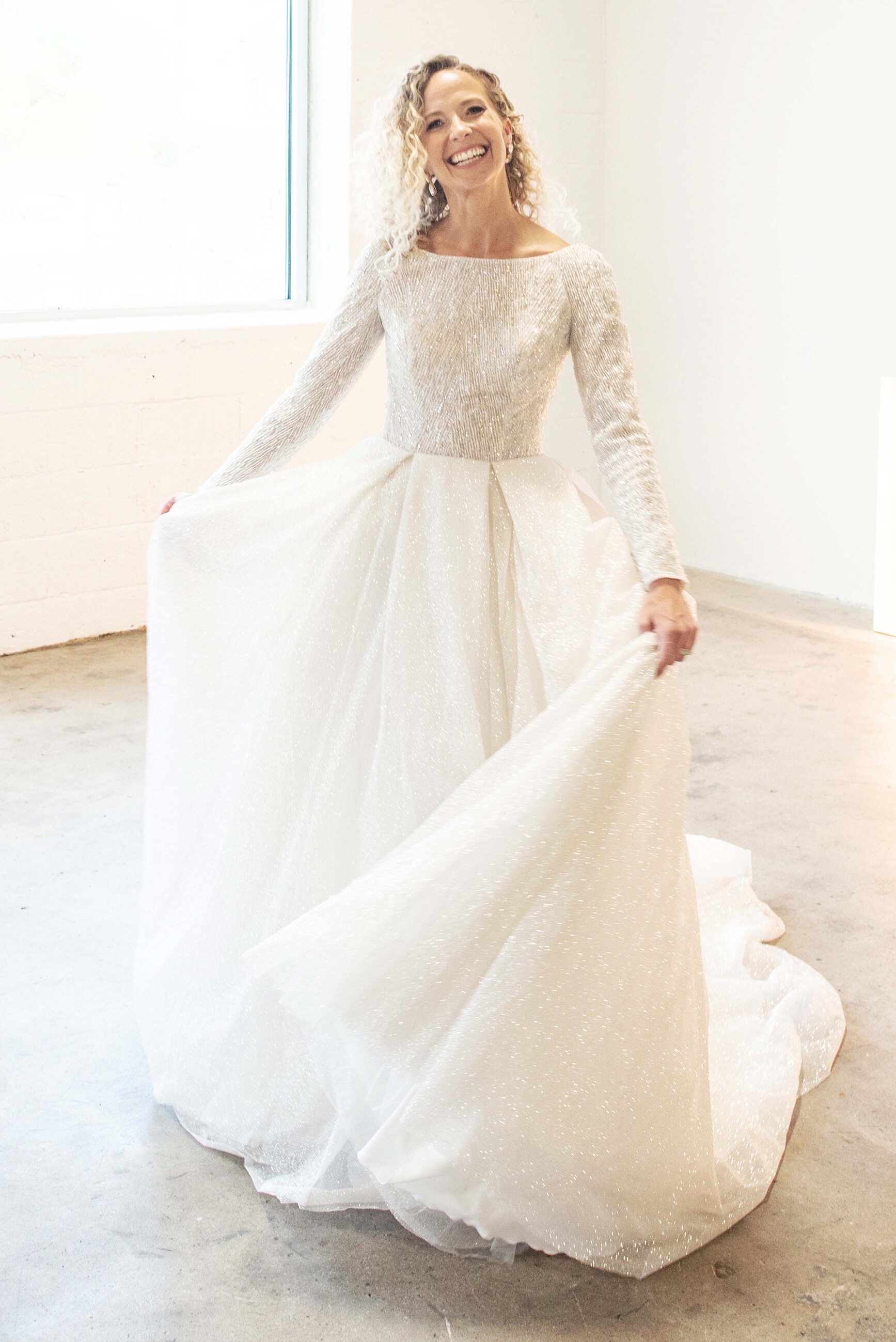 Model wearing a long sleeve wedding dress